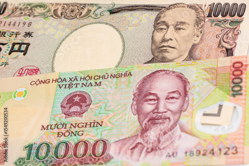 Wallpaper Mural 10000 Japanese yen and 10000 Vietnamese dong banknotes. International trade concept Torontodigital.ca