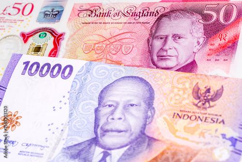 Wallpaper Mural 50 British pound and 10000 Indonesian rupee banknotes. International trade concept Torontodigital.ca