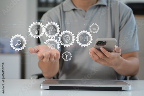 Artificial Intelligence technology. Man using a smartphone and laptop computer chatting with an intelligent artificial intelligence.