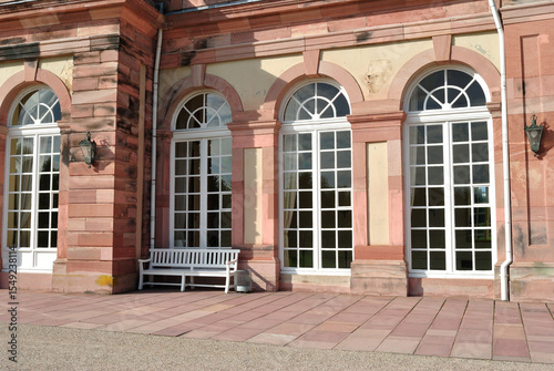 Wooden Bench beside Large Windows of German Baroque Building 