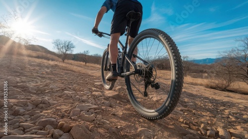 Wallpaper Mural Mountain biker riding on a rocky path in scenic landscape during golden hour Torontodigital.ca