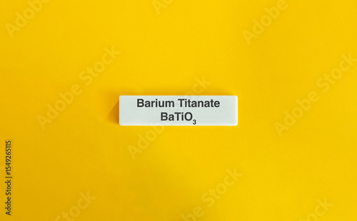 Barium Titanate BaTiO3 on Letter Tile with Yellow Background – Minimalist Scientific Concept