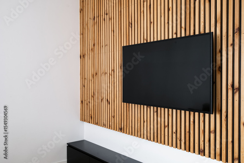 Modern living room with sleek LCD television mounted on wooden wall panel