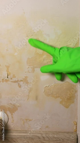 Vertical video of wet wall after leaking radiator heating pipes, 4k footage. Broken pipes.