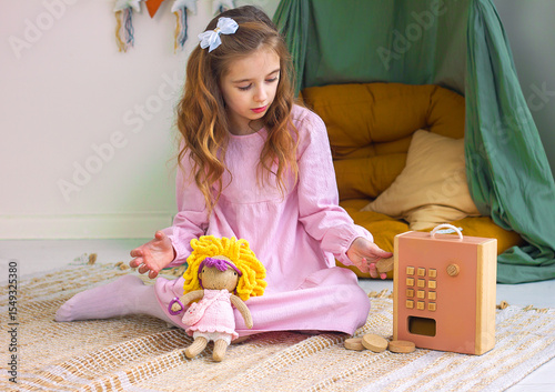 Cute little girl playing with toys sitting on the floor in a cozy children's room interior	