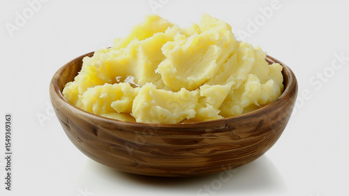 A delicious creamy pile of freshly made mashed potatoes in a wooden bowl