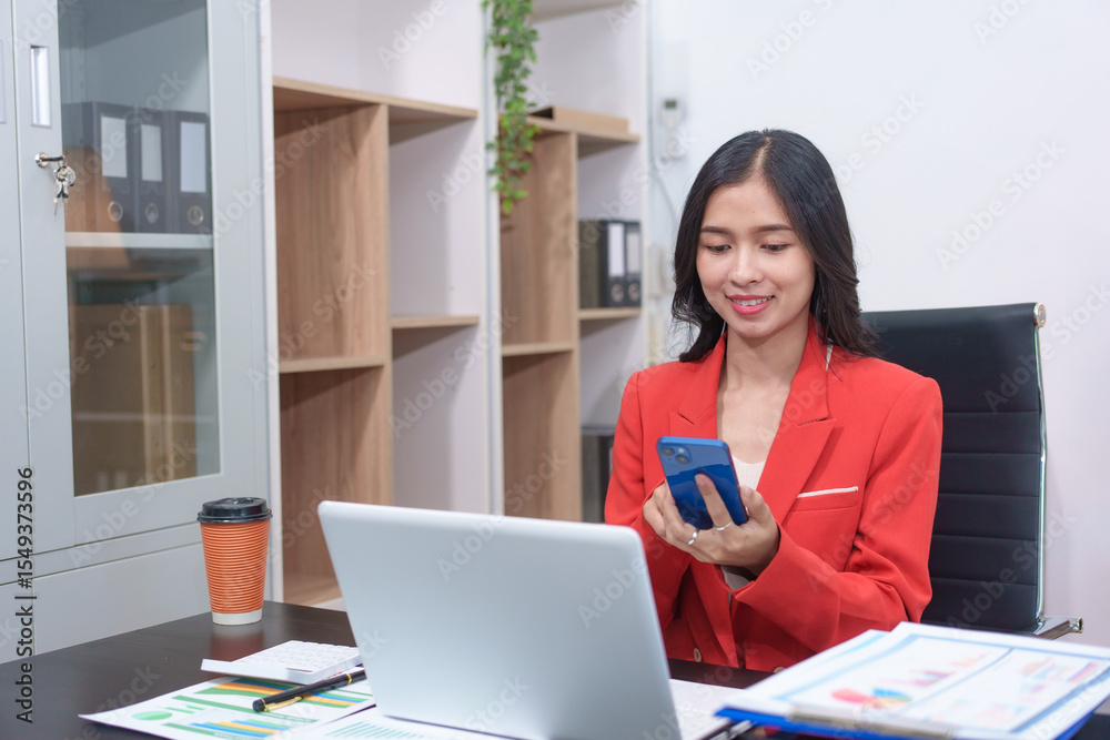 Cheerful business lady working on laptop in office, Asian happy beautiful businesswoman in formal suit work in workplace. Attractive female employee office worker smile. Cheerful business lady working on laptop in office, Asian happy beautiful businesswoman in formal suit work in workplace. Attractive female employee office worker smile.