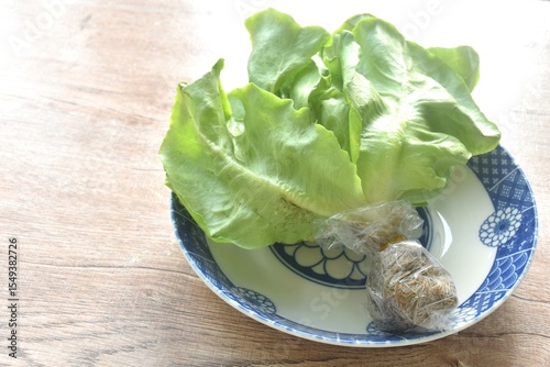 fresh green cos or  Romaine lettuce vegetable salad with drop of water arranging on plate