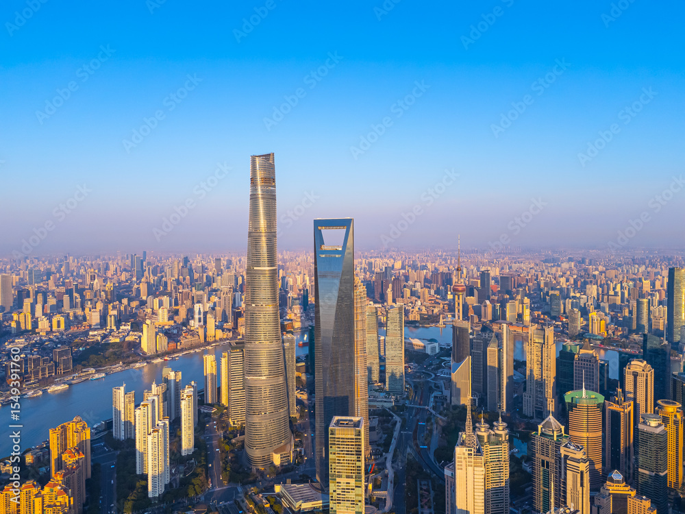 Fototapeta premium Aerial view of Shanghai skyscrapers in downtown with winding river on sunny day.