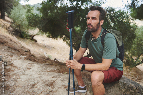 Man Resting During Hike in Scenic Mountain Environment