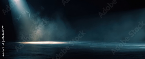 The spotlight illuminating a dramatic empty stage filled with mysterious fog.