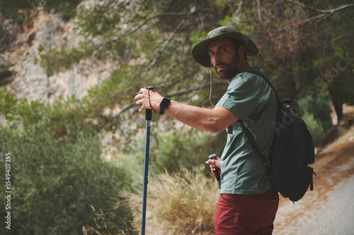 Hiker Exploring a Scenic Mountain Trail with Approaching Trees