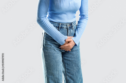 Medical or gynecological problems, healthcare concept. Woman covering his crotch with both hands. Sick woman hands holding pressing her crotch lower abdomen