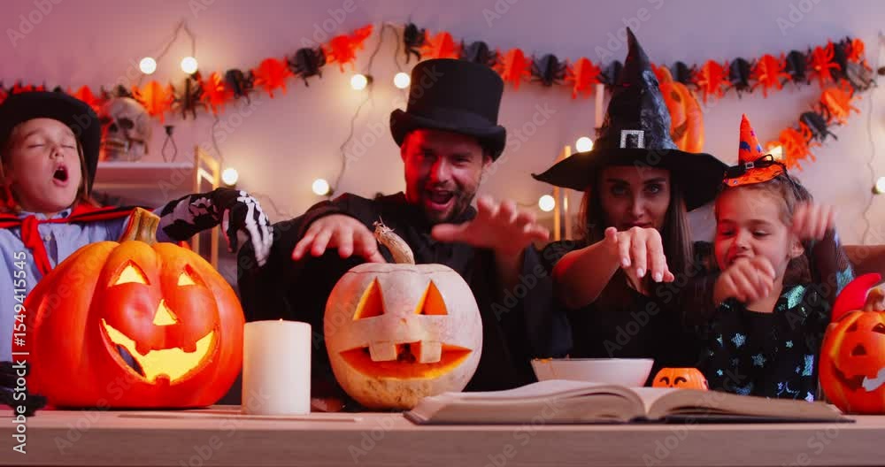Halloween family happy holiday fun, parents, funny kid with pumpkin lantern playing in costume for dress ups party night event, role playing carnival, spooky horror cosplay, holiday garland light