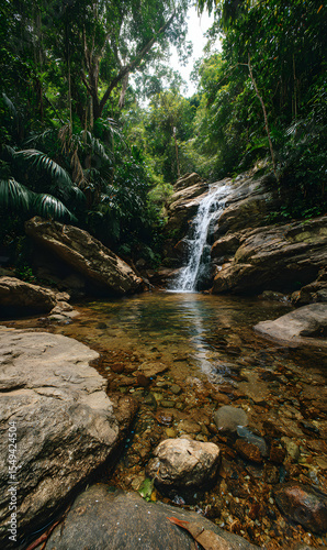 Tranquil cascade flowing over mossy rocks in a tropical rainforest paradise creating a serene and peaceful environment