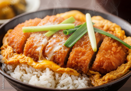 Classic Japanese Katsudon: Deep-fried pork cutlet (Tonkatsu) simmered with egg and onion, served over steamed rice in a bowl.