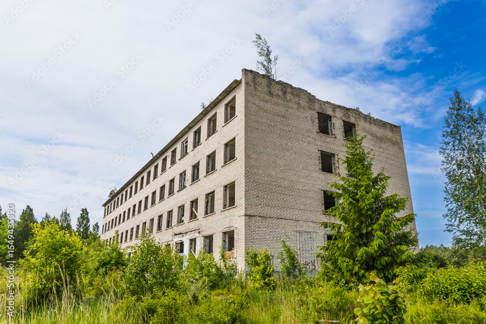 Obraz premium Abandoned Concrete Building at Former Radar Base Village Irbene, Latvia, Reclaimed by Nature