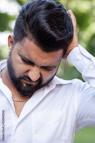 South Asian, Indian man having one-side migraine headache