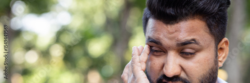 South asian man having vision problem, eye irritation, red eye, dry eye or eye inflammation, optical or eye health care concept