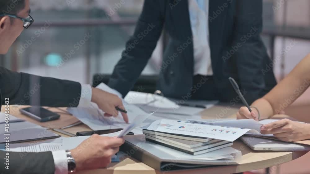 Business people analyzing charts information on documents, using files and papers to create report analysis. Colleagues working with diagrams