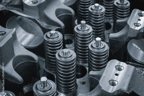 Dark blue close-up of engine valve springs. springs are black and shiny. mage has an industrial and mechanical mood, service repair car engine concept background