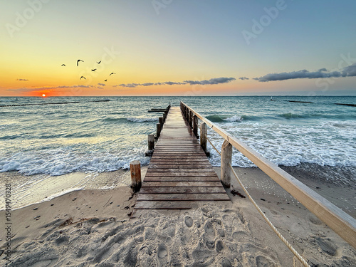 Romantic Sunset Stroll: A Wooden Pier Overlooking Gentle Waves and a Golden Horizon, Perfect for Travel and Vacation Memories