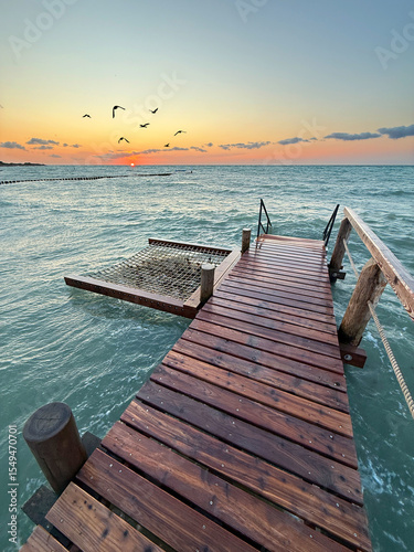 Wooden Pier with a Hammock Gently Swaying Over Calm Waters, Perfect for Travel and Relaxation