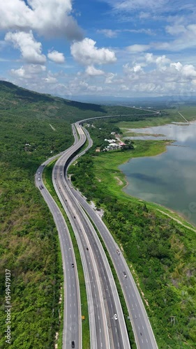 Vertical video Drone shot The M6 motorway Expressway Nakhon Ratchasima Province - Bang Pa-in Lam Ta Khong River and Mountain Drone shot of scenic landscape rural place traffic. Motorway Korat Thailand