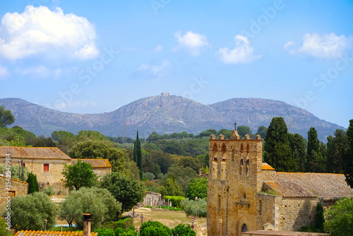 Sant Esteve church in Peratallada in front of mountains by the city Toroella de Mntgri, Forallac, Catalonia, Costa Brava, Spain