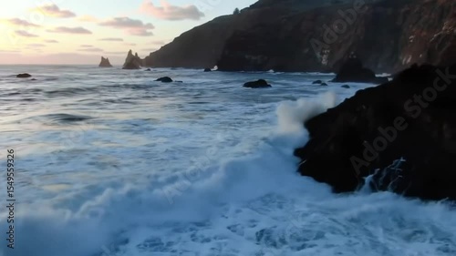 Dramatic Ocean Waves Crashing on Rocky Coast at Sunset