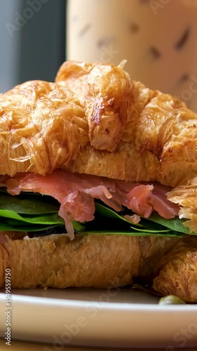 Delicious Croissant Sandwich made with Egg and Avocado and salmon, traditional french cuisine, france cafe, morning breakfast brunch menu. . High quality 4k footage