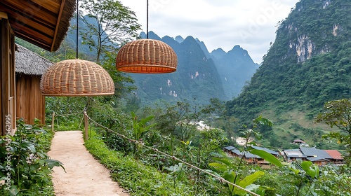 Festival symbols crafted from woven materials suspended from ropes stretched between traditional wooden houses along a narrow pathway