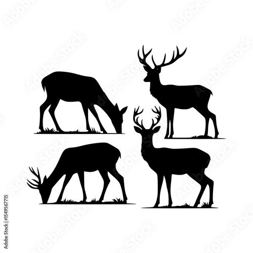 Four deer silhouettes grazing and standing