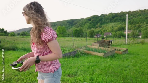 portrait of young female smiling and holding bowl full of freshly picked herbs from the garden. Homesteading and slow life concept