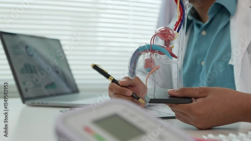A male patient with a urinary tract infection visits a doctor at a hospital examination table to discuss his symptoms. Talk about an enlarged prostate.