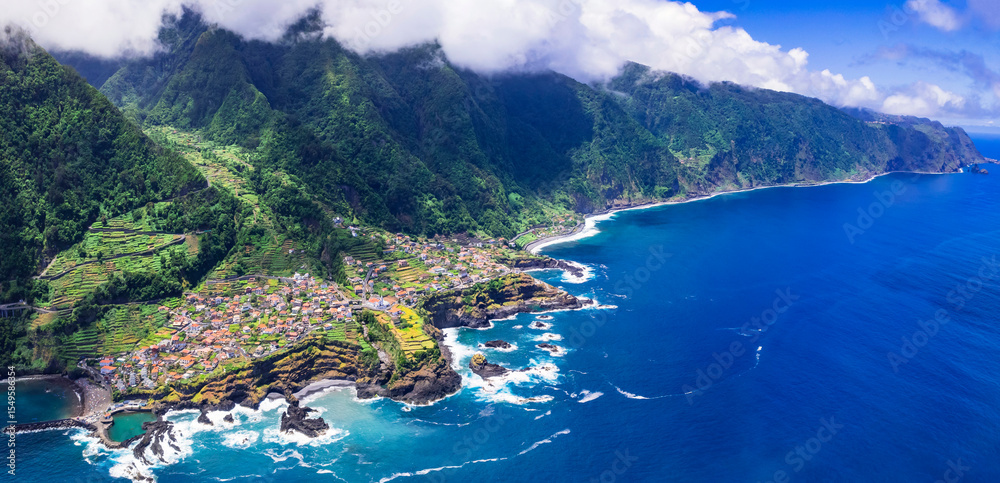 Obraz premium Madeira island beautiful nature scenic places. Stunning Seixal coast and village, aerial drone view of rocky coast and natural lava swimming pools. Portugal travel