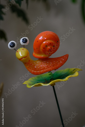 Wallpaper Mural Plastic orange snail on a spring as a decoration. 
 Torontodigital.ca