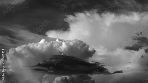 Time-lapse of white clouds and gathering storm clouds in a blue sky; fluffy moving clouds, Black and White