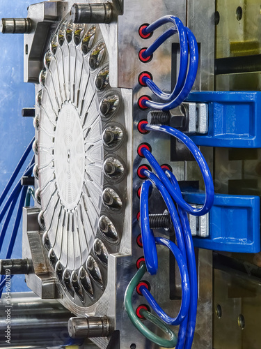 Plastic press machinery used in industrial manufacturing processes at a factory facility for producing various plastic components