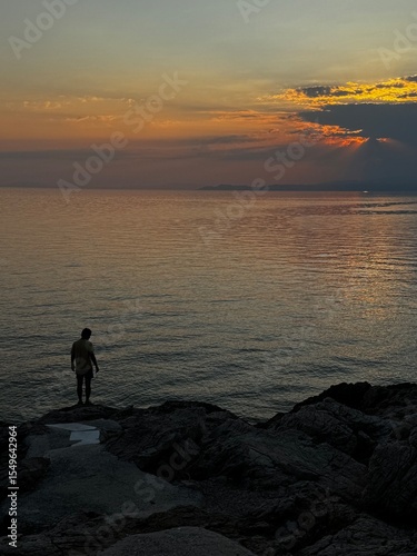 Wallpaper Mural Gentle waves and soft light illuminate the sea at sunset in Thassos, with distant mountains on the horizon. Torontodigital.ca