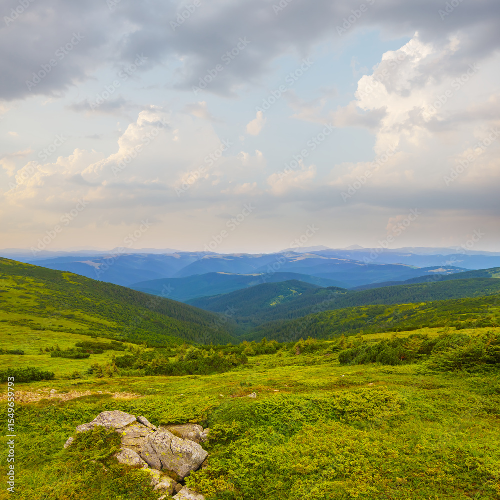 Fototapeta premium beautiful green mountain backbone under blue cloudy sky