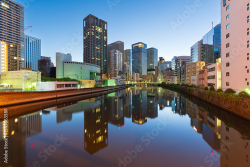 Osaka, Japan cityscape on the Okawa River at twilight. photo