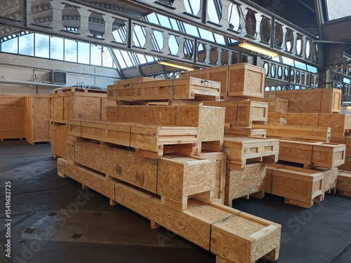 Industrial wooden crates stacked in warehouse ready for packaging and shipping.