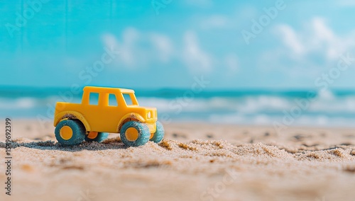 Yellow toy truck on sandy beach, ocean backdrop