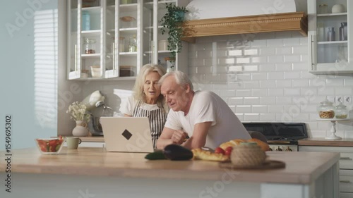 Video call by modern laptop, old spouses waving hands to web camera, smiling. Happy granny and grandpa calling by internet to friends or family, modern technology of distant communication, chat online