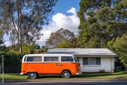 Orange van parked in front of a house, sunny day