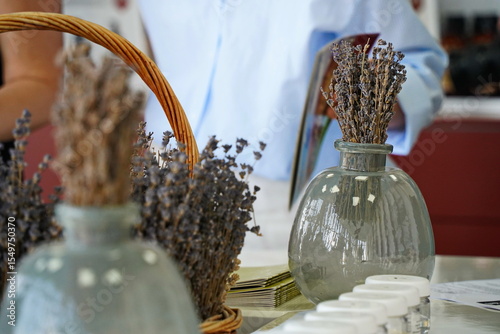 Dried lavender bouquet in a clear glass vase. Minimalist natural decor with rustic charm, perfect for home interior, aromatherapy, spa, and eco-friendly lifestyle concepts.