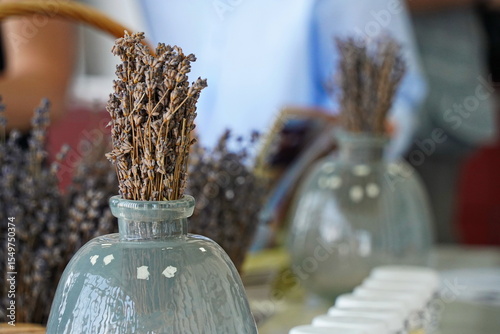 Dried lavender bouquet in a clear glass vase. Minimalist natural decor with rustic charm, perfect for home interior, aromatherapy, spa, and eco-friendly lifestyle concepts.