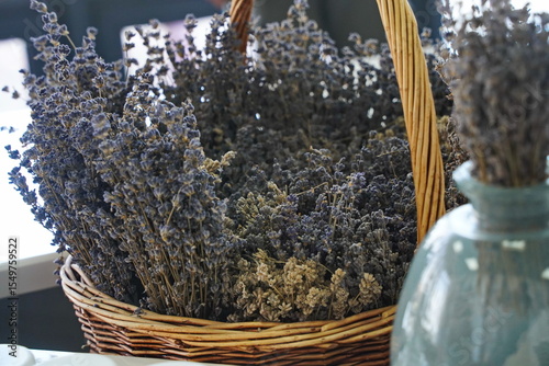 Dried lavender bouquet in a woven basket. Rustic floral arrangement for home decor, aromatherapy, and countryside vibes. Natural, eco-friendly, vintage-style composition.
