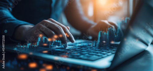 Close-up of hands working on a laptop with overlaid financial data visualizations